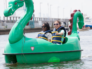 Two women paddling a dragon boat at The Independence Seaport Museum