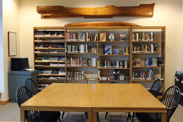 Table in front of glass front bookshelf at The Independence Seaport Museum