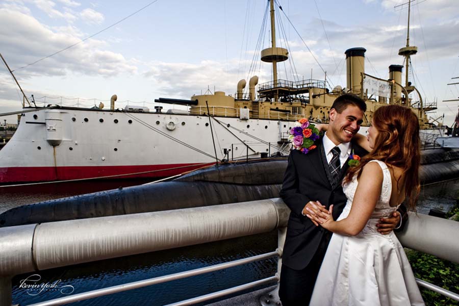 Bride and groom posing for a photo in front of Cruiser Olympia at The Independence Seaport Museum