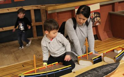 Mother and son looking a models of a ship at The Independence Seaport Museum