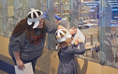 Mother and daughter making rubbings of etched glass at The Independence Seaport Museum