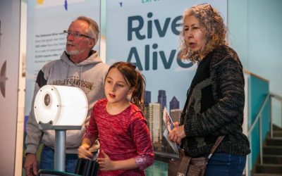 Young girl with parents looking at the River Alive exhibit at The Independence Seaport Museum